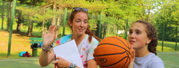 Landsports director teaching basketball at Camp Kippewa in Maine