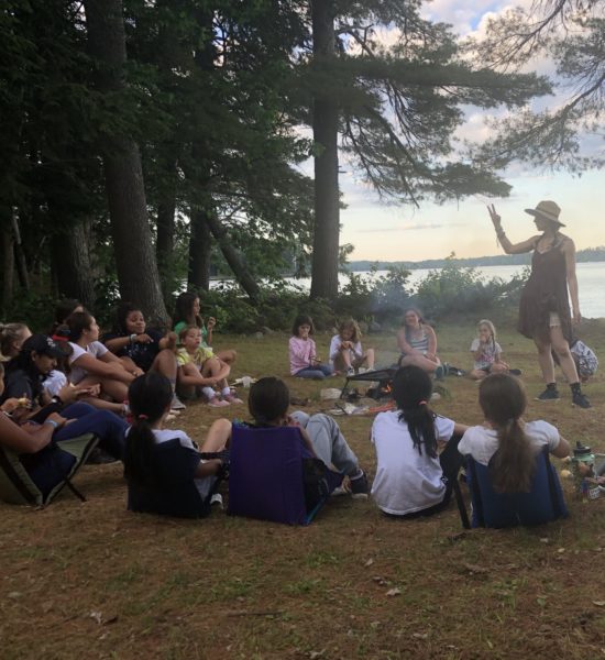 Kippewa campers at a campfire overlooking Lake Cobbosseecontee